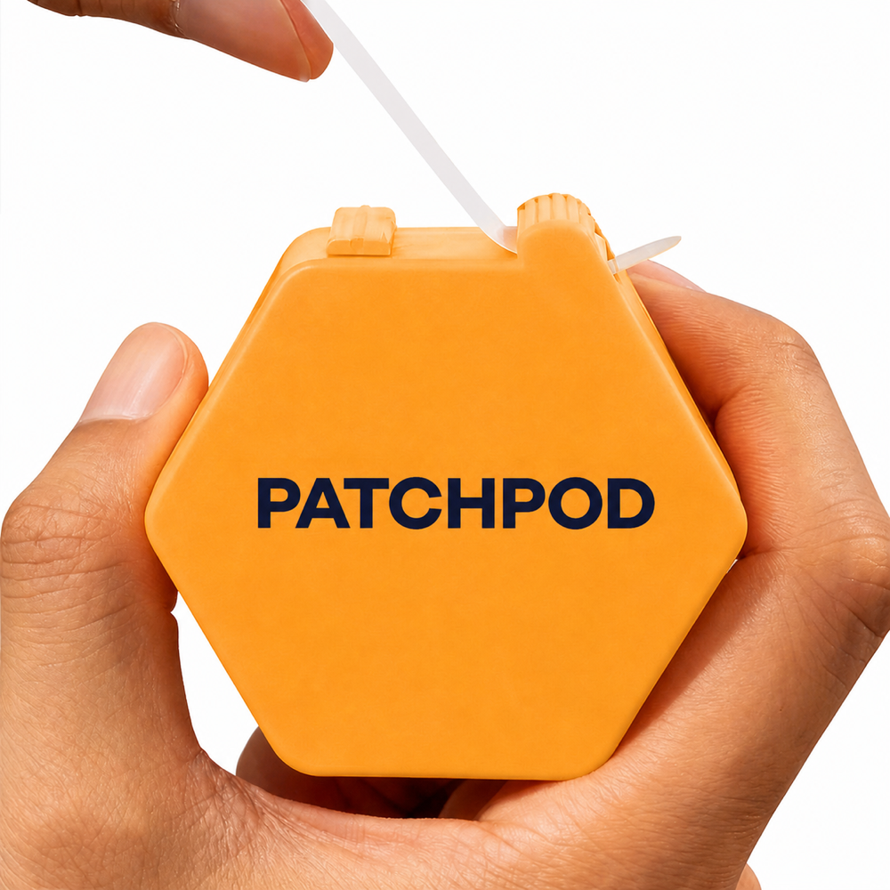 Hands holding a branded orange-yellow PatchPod case while pulling its backing strip